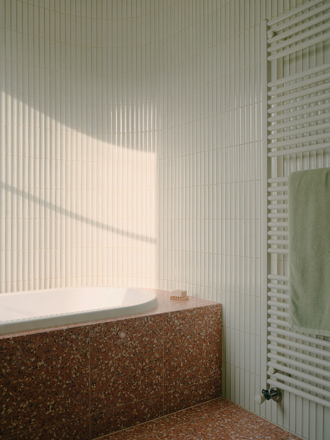 Minimalist bathroom design with textured tiles, sleek fixtures, and natural stone accents.