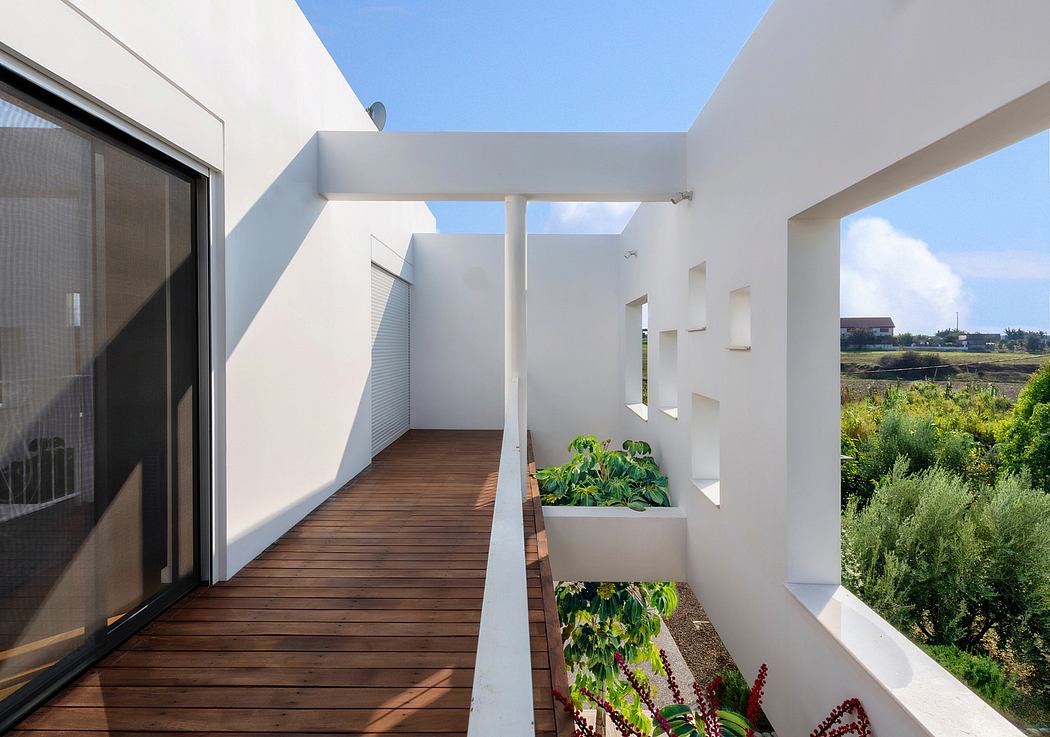 A modern architectural design featuring a wooden walkway, potted plants, and a view of the landscape.