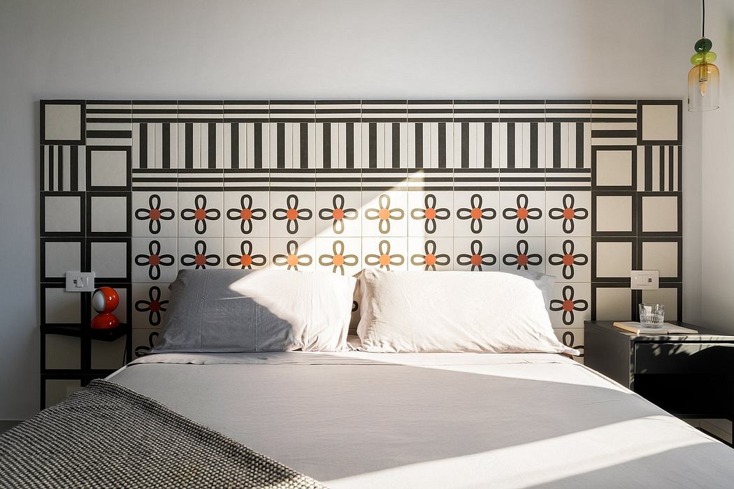 Modern bedroom design with patterned headboard, wall shelving, and lighting fixtures.