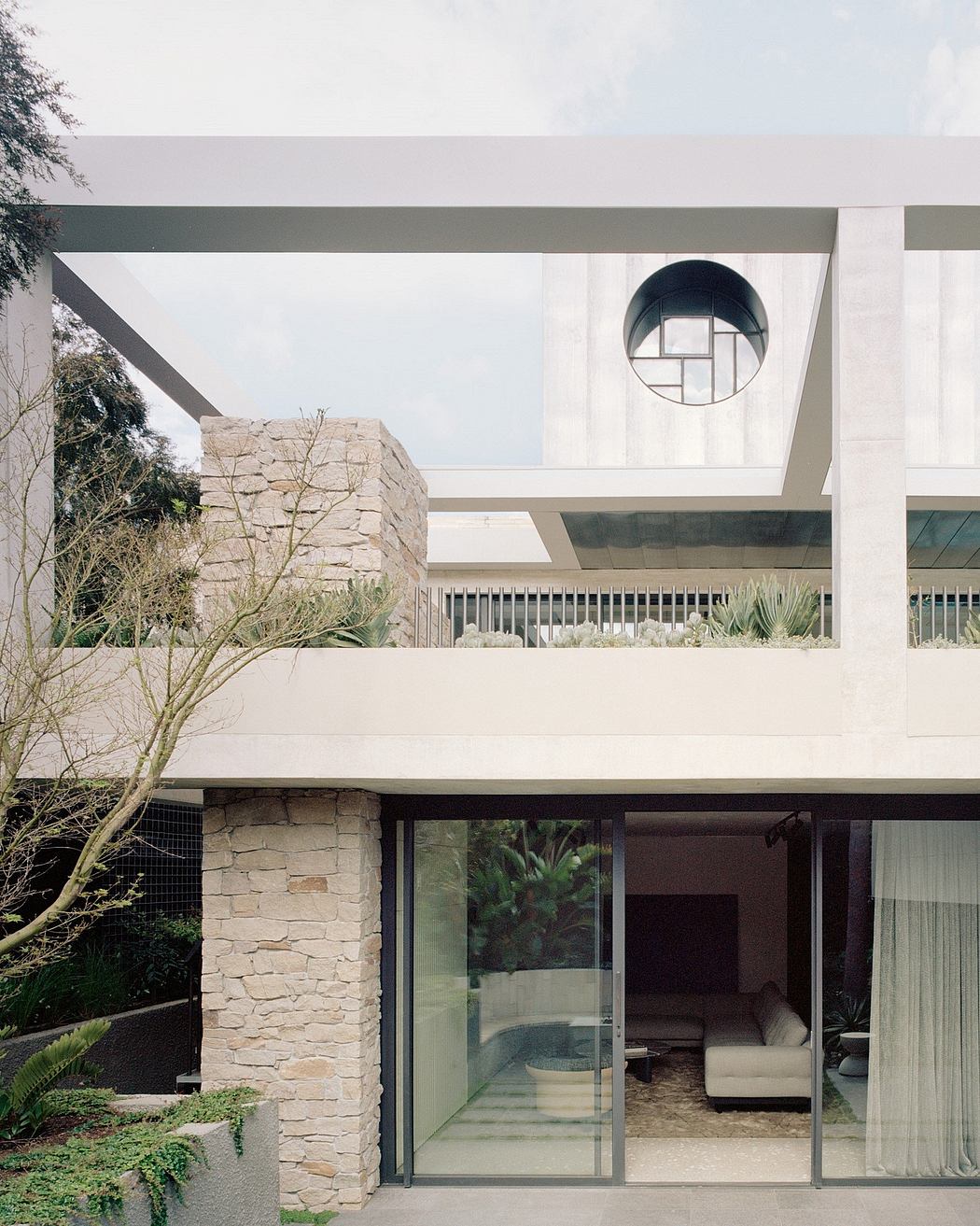 Modern architectural details with stone, glass, and sleek lines complement the natural surroundings.