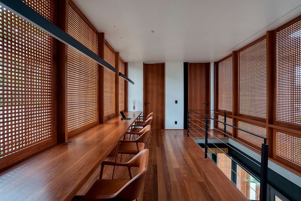 A modern, minimalist room with wooden screens, a long countertop, and sleek furniture.