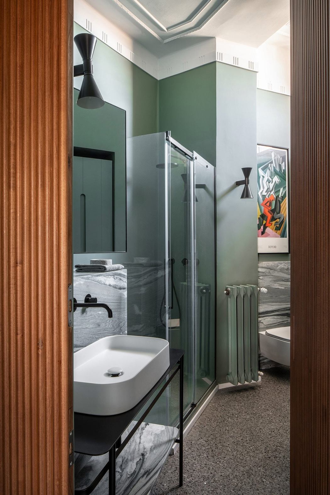 Sleek and modern bathroom design with glass shower enclosure, marble vanity, and warm wood accents.