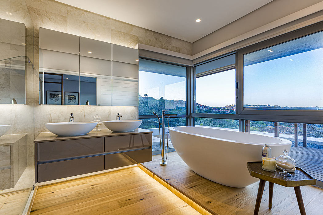 Spacious bathroom with scenic views, modern fixtures, and a freestanding bathtub.