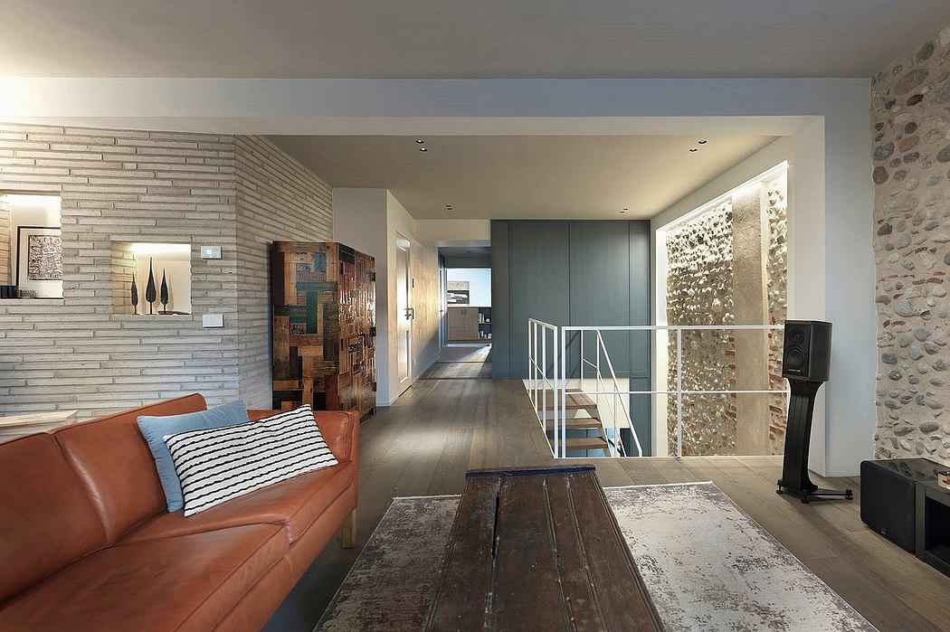 Open-concept living space with exposed brick, wooden furniture, and architectural details.