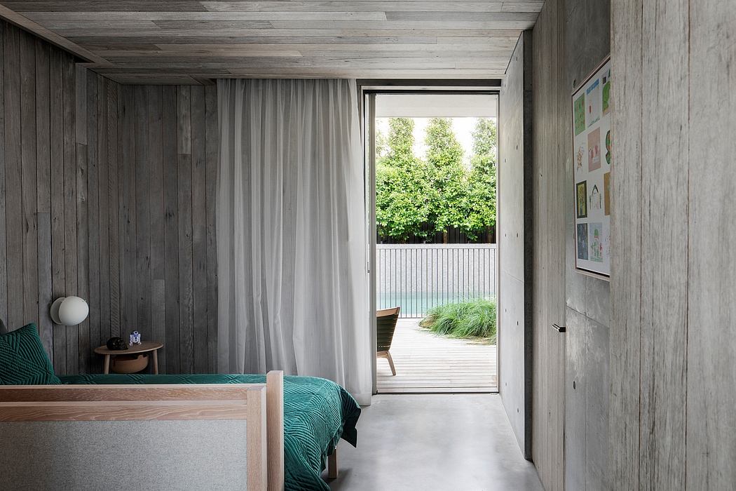 Cozy bedroom with rustic wooden walls, floor-to-ceiling curtains, and views of lush greenery.