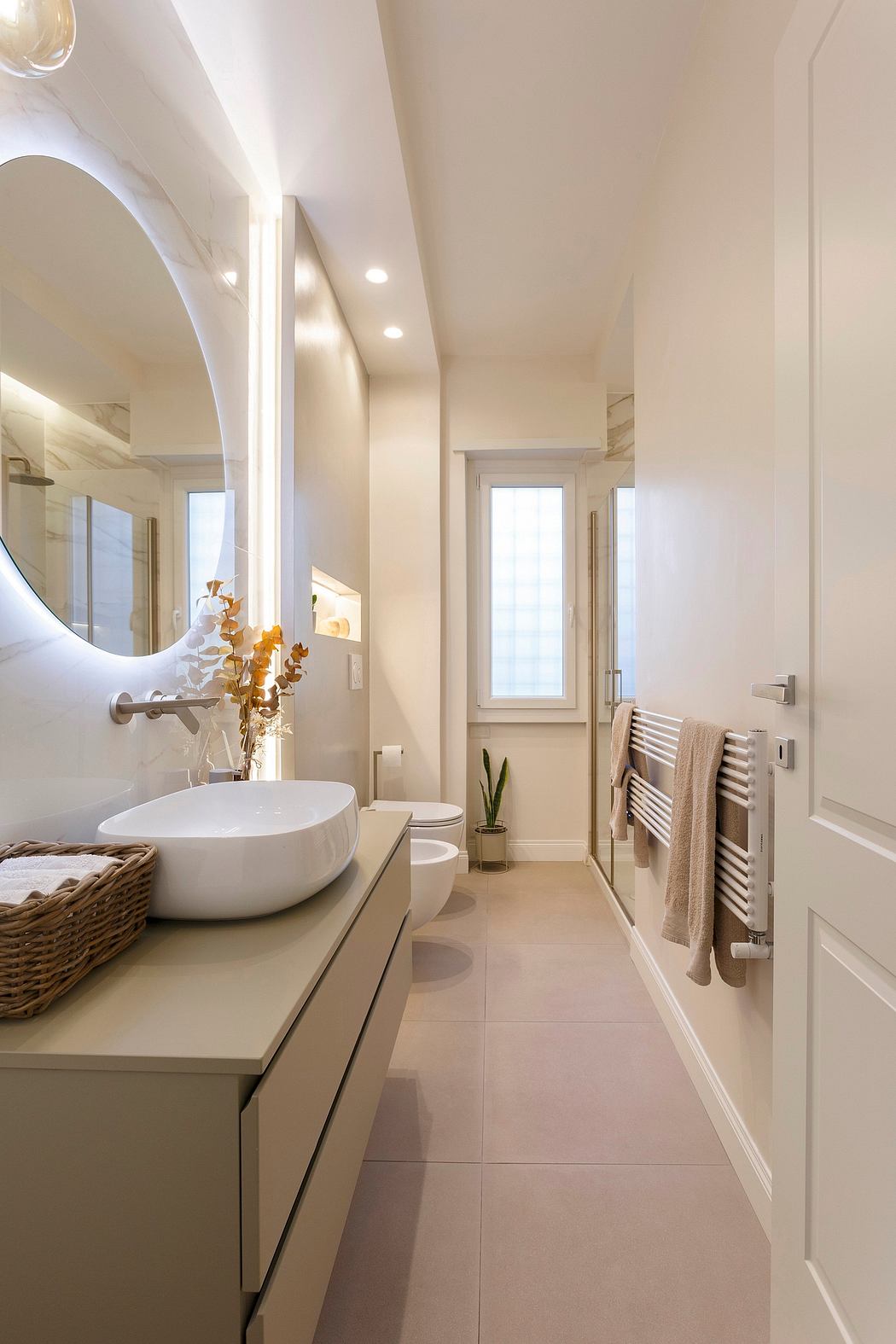 Elegant bathroom with minimalist vanity, vessel sink, and warm lighting accents.