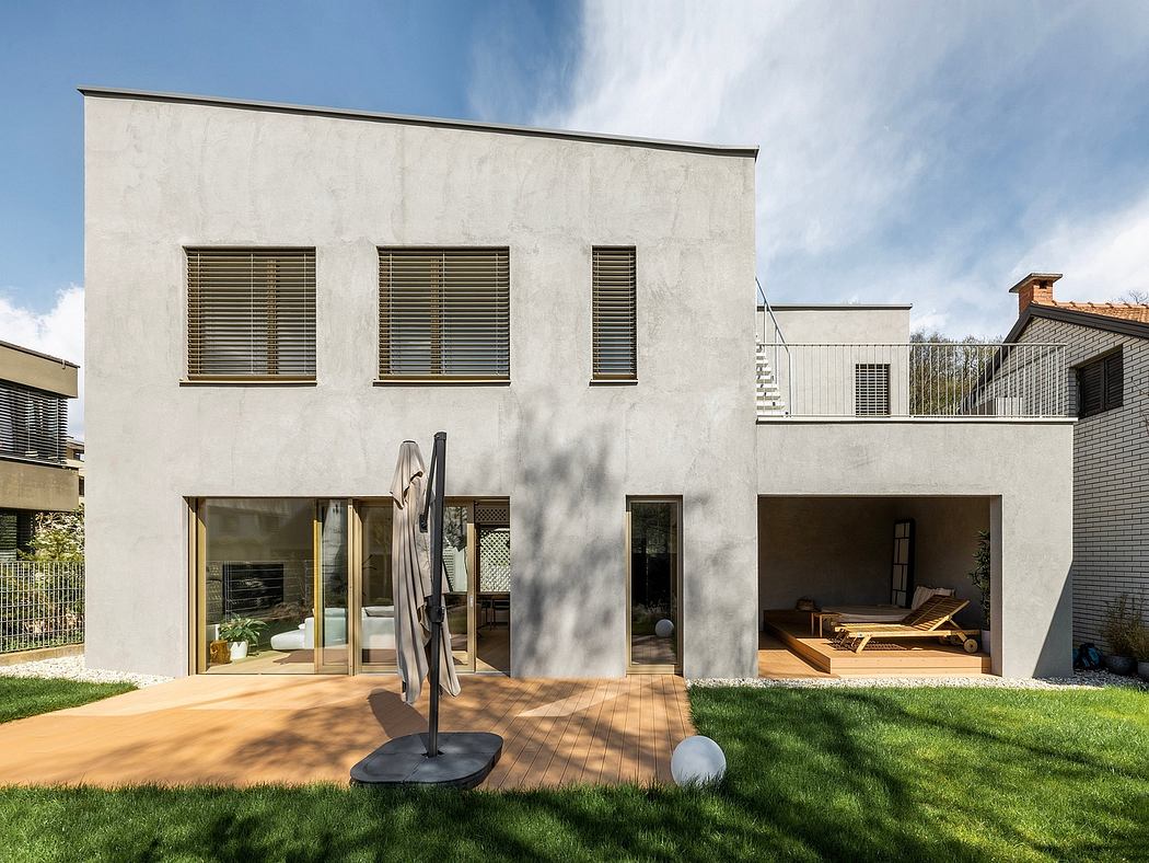 Striking modern architecture with glass walls, wooden decks, and lush greenery.