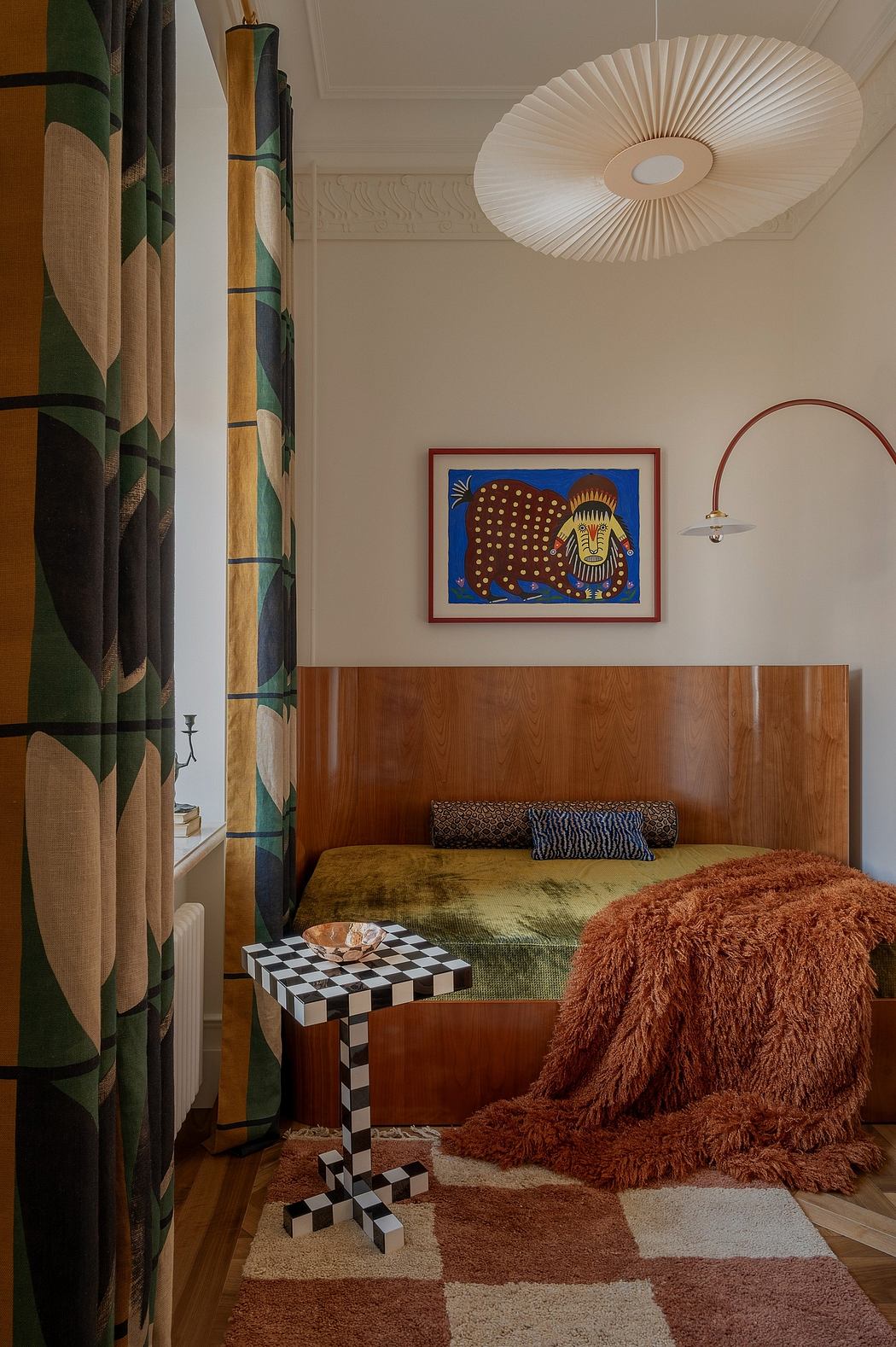 Eclectic bedroom with bold patterned curtains, geometric side table, and vibrant wall art.
