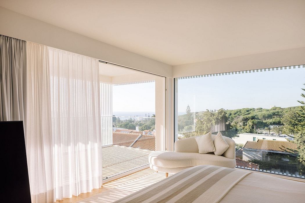 Spacious bedroom with floor-to-ceiling windows, cozy lounge, and scenic outdoor view.