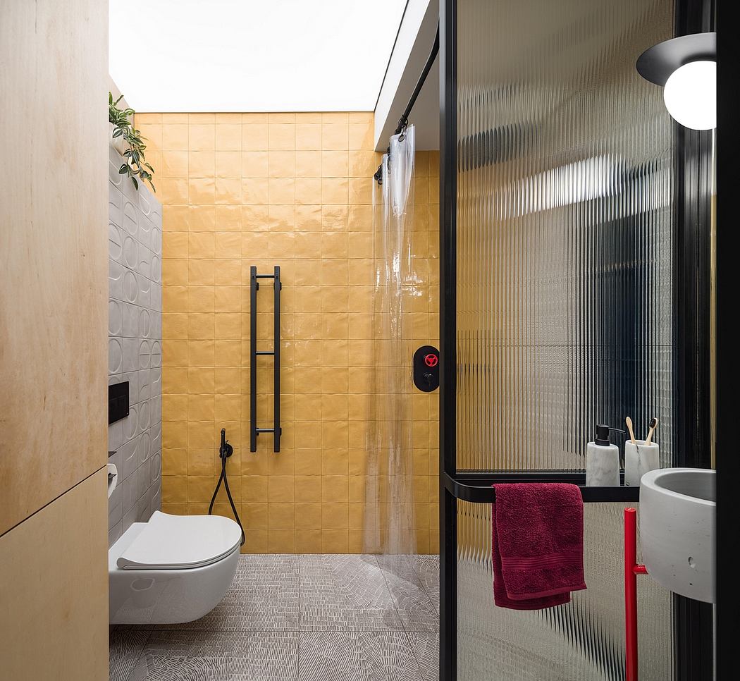 Modern bathroom with textured tile walls, sleek glass shower, and minimalist design elements.