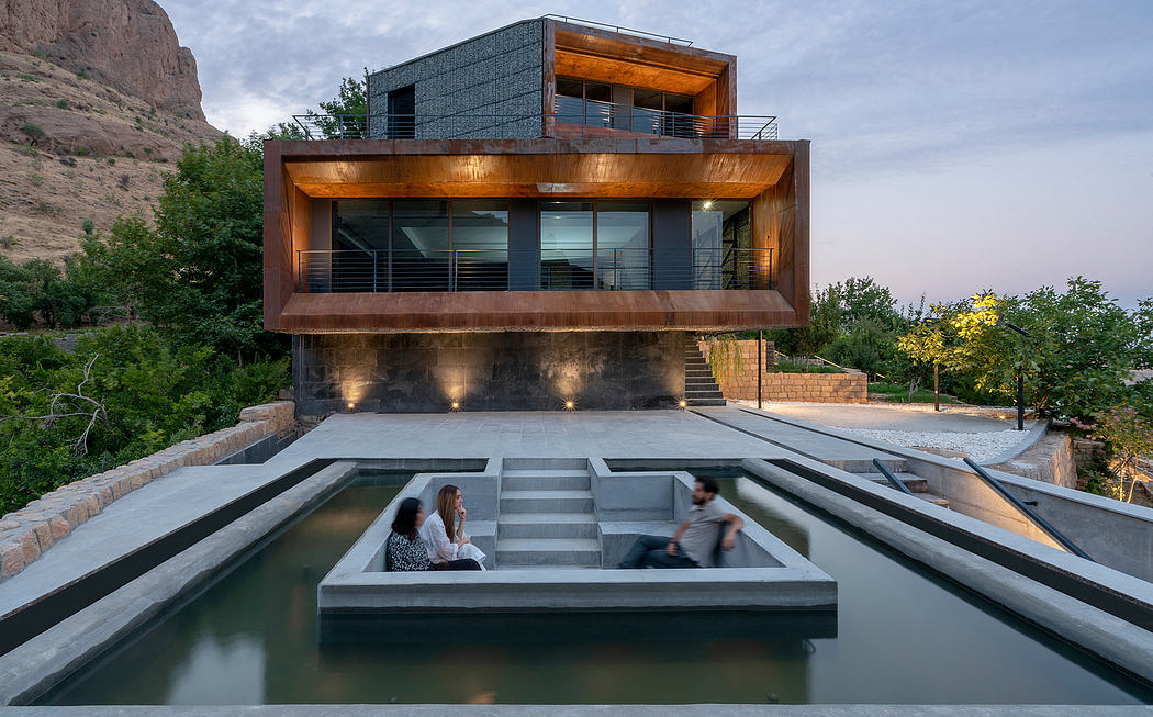 A modern, multi-level home with an outdoor water feature, wood and glass accents.