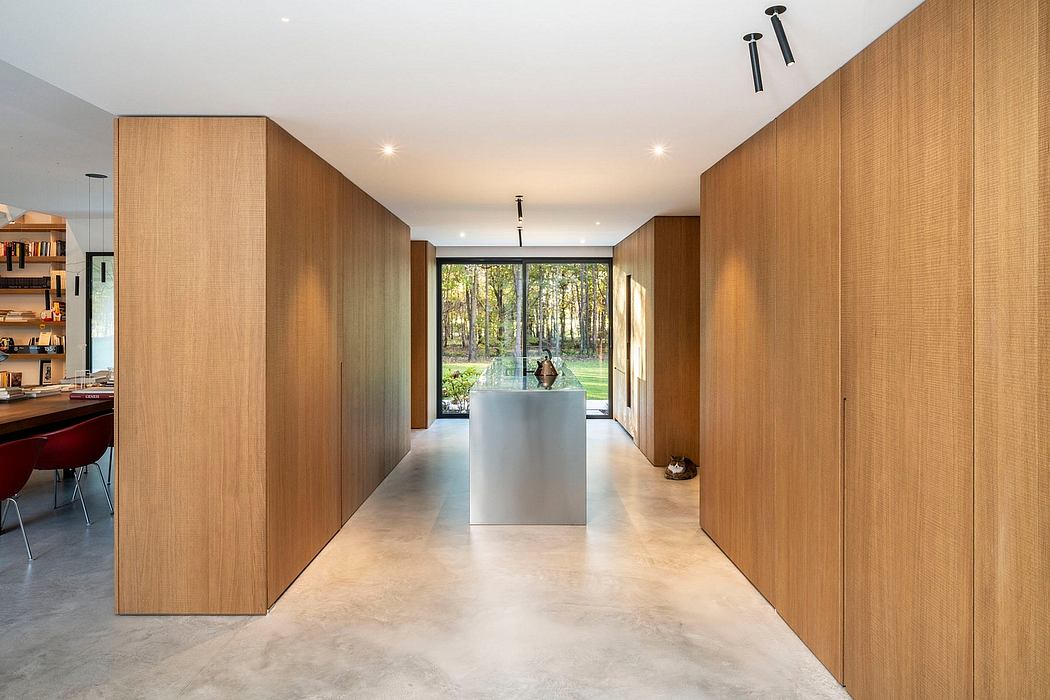Minimalist modern interior with wood-paneled walls, concrete floor, and glass walls.