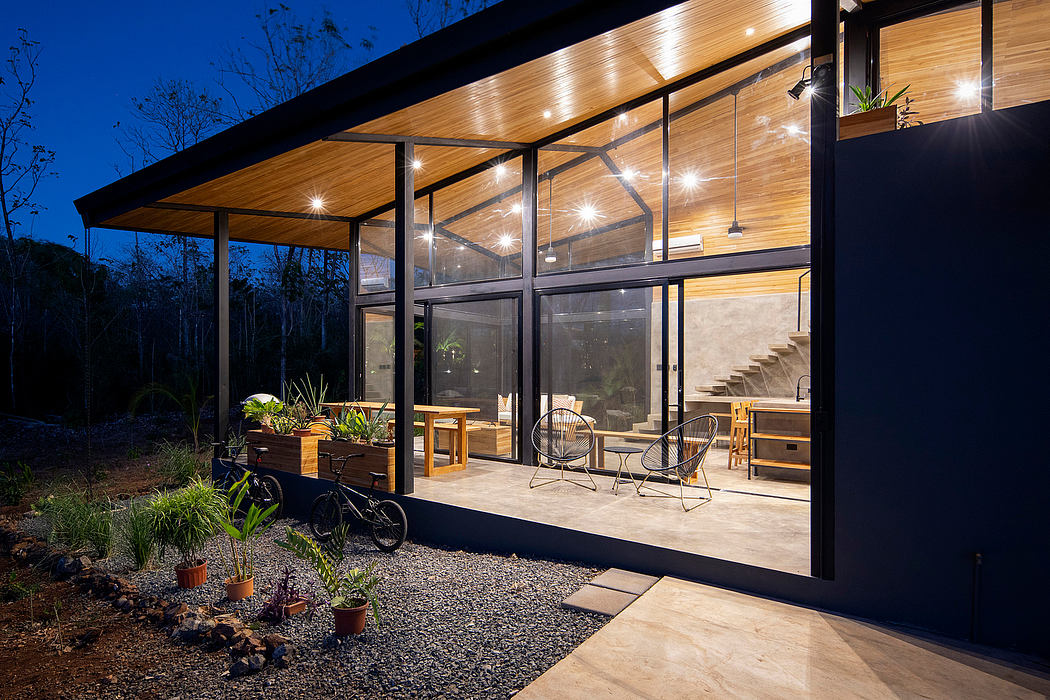 Sleek, modern cabin with wooden beams, glass walls, and cozy outdoor seating area.