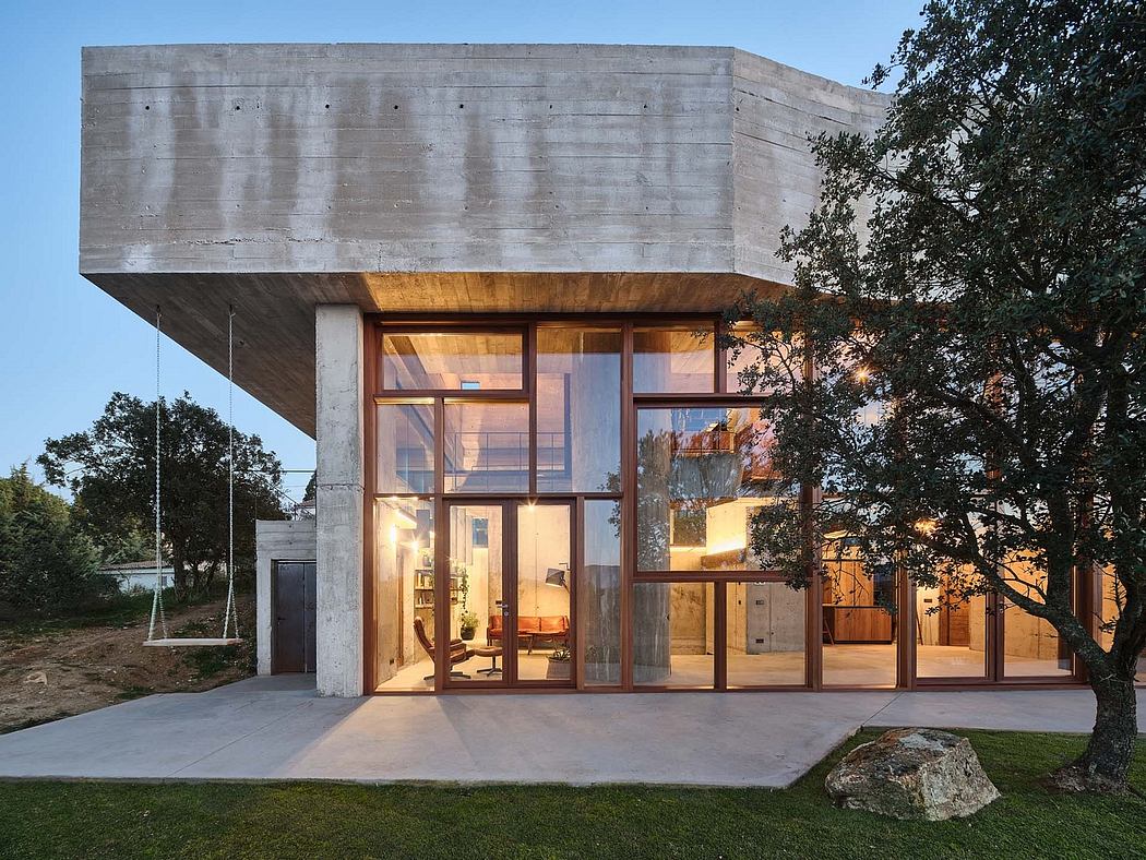 Concrete and wood structure with large glass walls and a cantilevered roof.