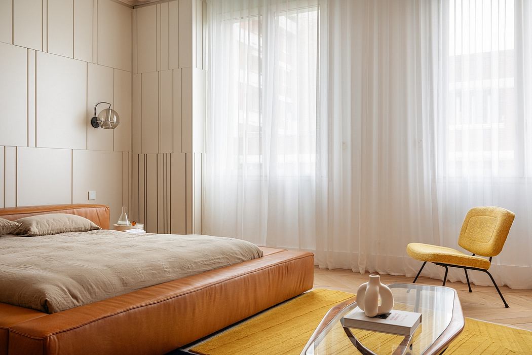 Sleek, minimalist bedroom with warm wood tones, light curtains, and a modern armchair.