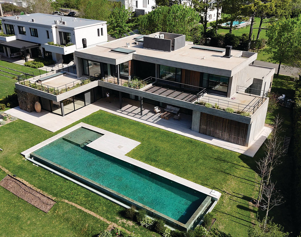 Sleek, modern architectural design with a large outdoor pool and lush greenery.