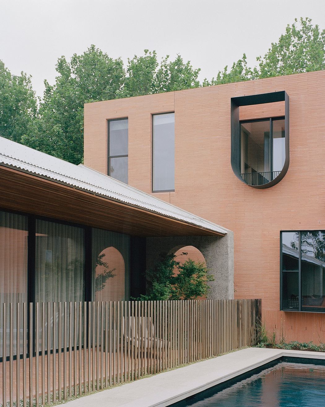 Sleek, modern architecture with wooden facade, geometric windows, and a pool.