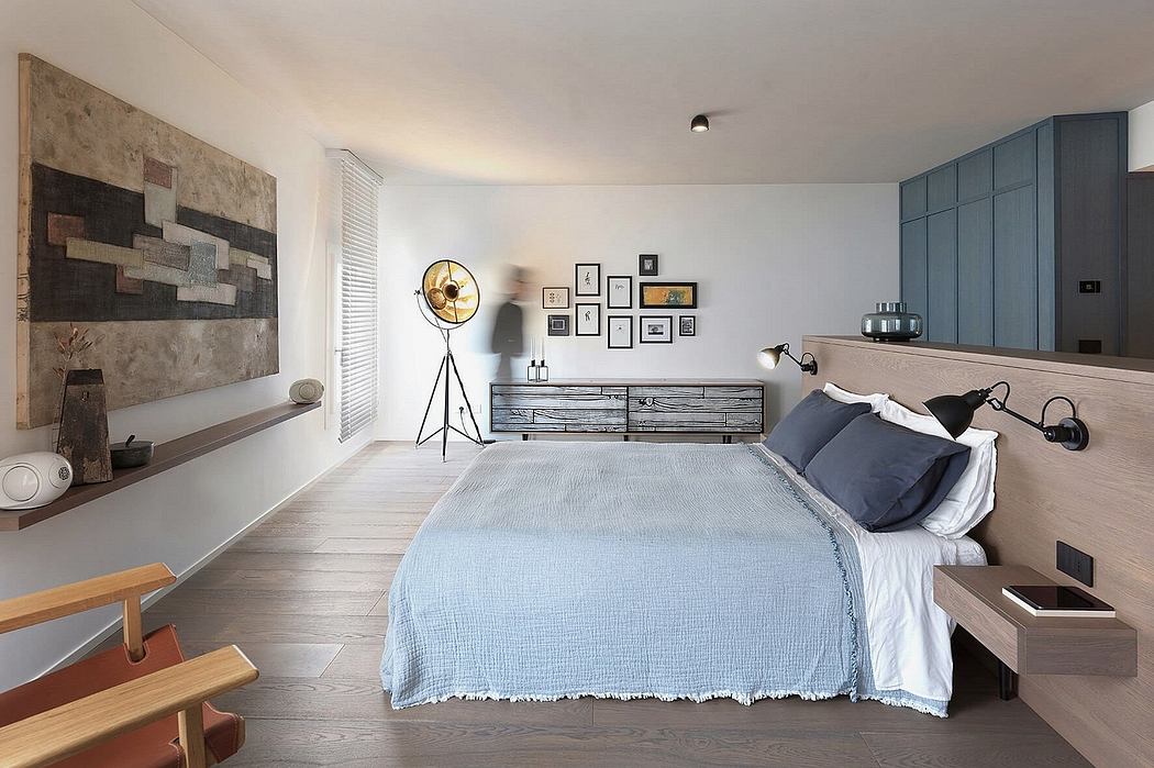A modern, minimalist bedroom with a wooden platform bed, built-in cabinetry, and decorative wall art.