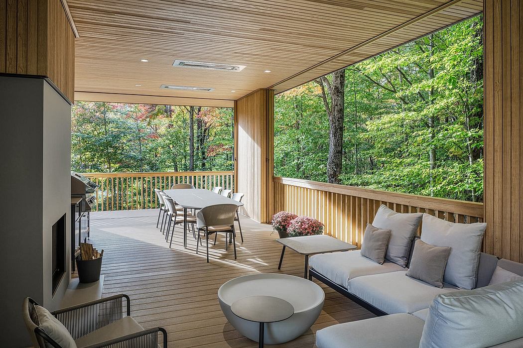 Cozy wooden deck with modern furniture and beautiful forest views.