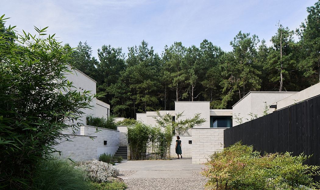 Minimalist, monolithic structures nestled amid lush greenery, creating an serene ambiance.