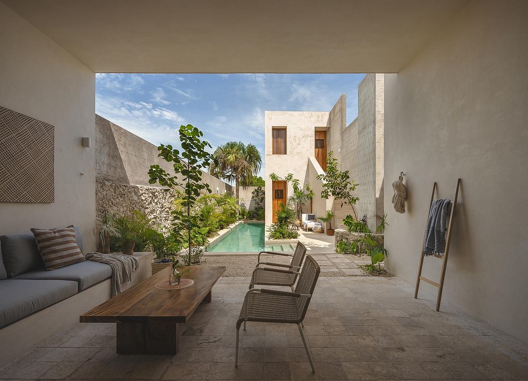 Serene courtyard with sleek modern architecture, lush greenery, and a small pool.