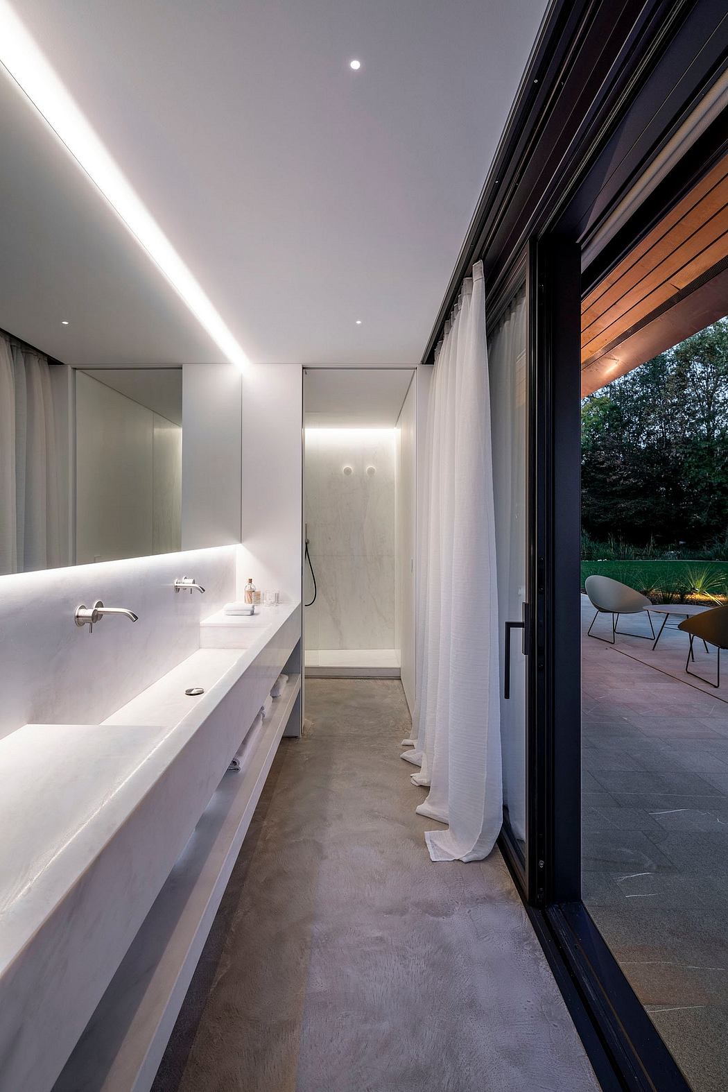 Minimalist bathroom with large window, concrete floor, and floating vanity.
