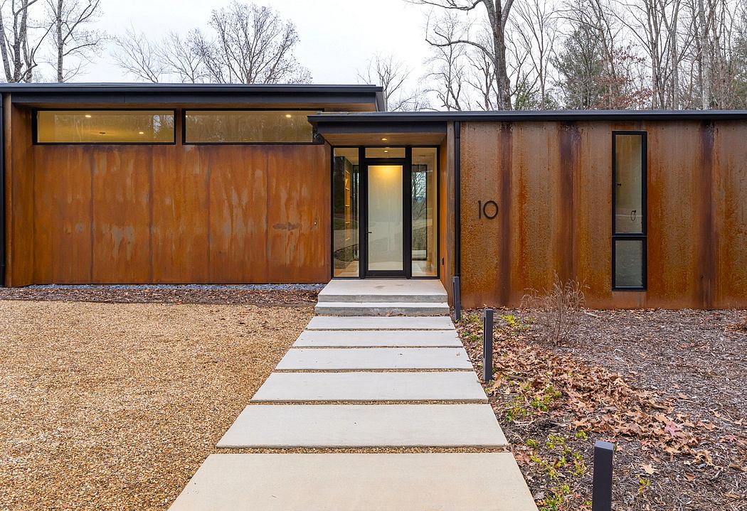 A modern, rustic home with a distinctive copper façade, prominent entrance, and sleek design.