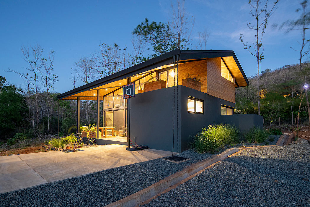 A modern, two-story cabin with a wooden exterior, large windows, and a covered porch.
