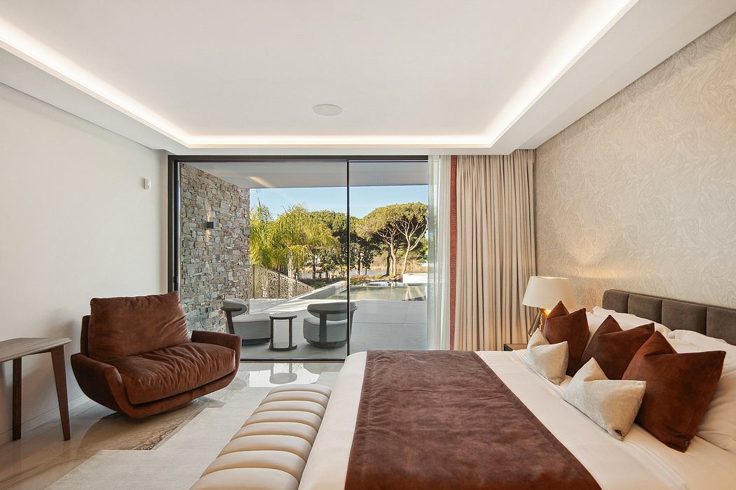 Spacious bedroom with floor-to-ceiling windows, modern decor, and an inviting outdoor view.