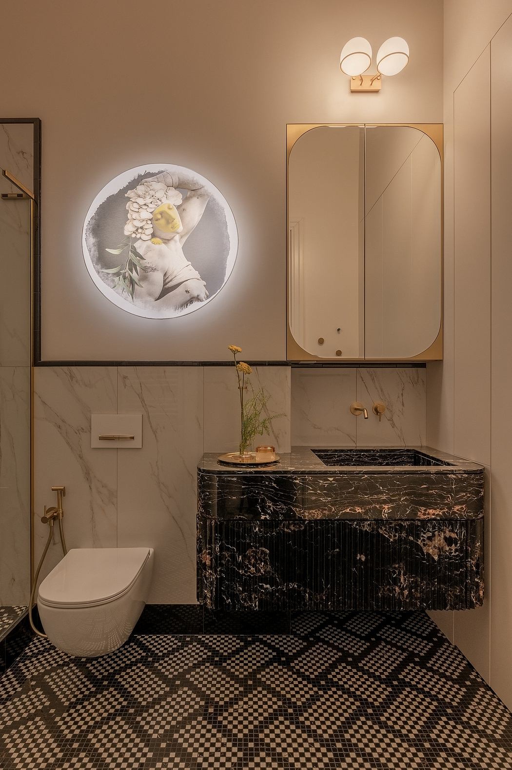 A luxurious bathroom with a sleek black marble vanity, ornate floral artwork, and a mosaic tile floor.