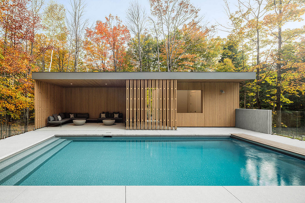 Contemporary pool house with sleek wooden exterior and integrated seating area.