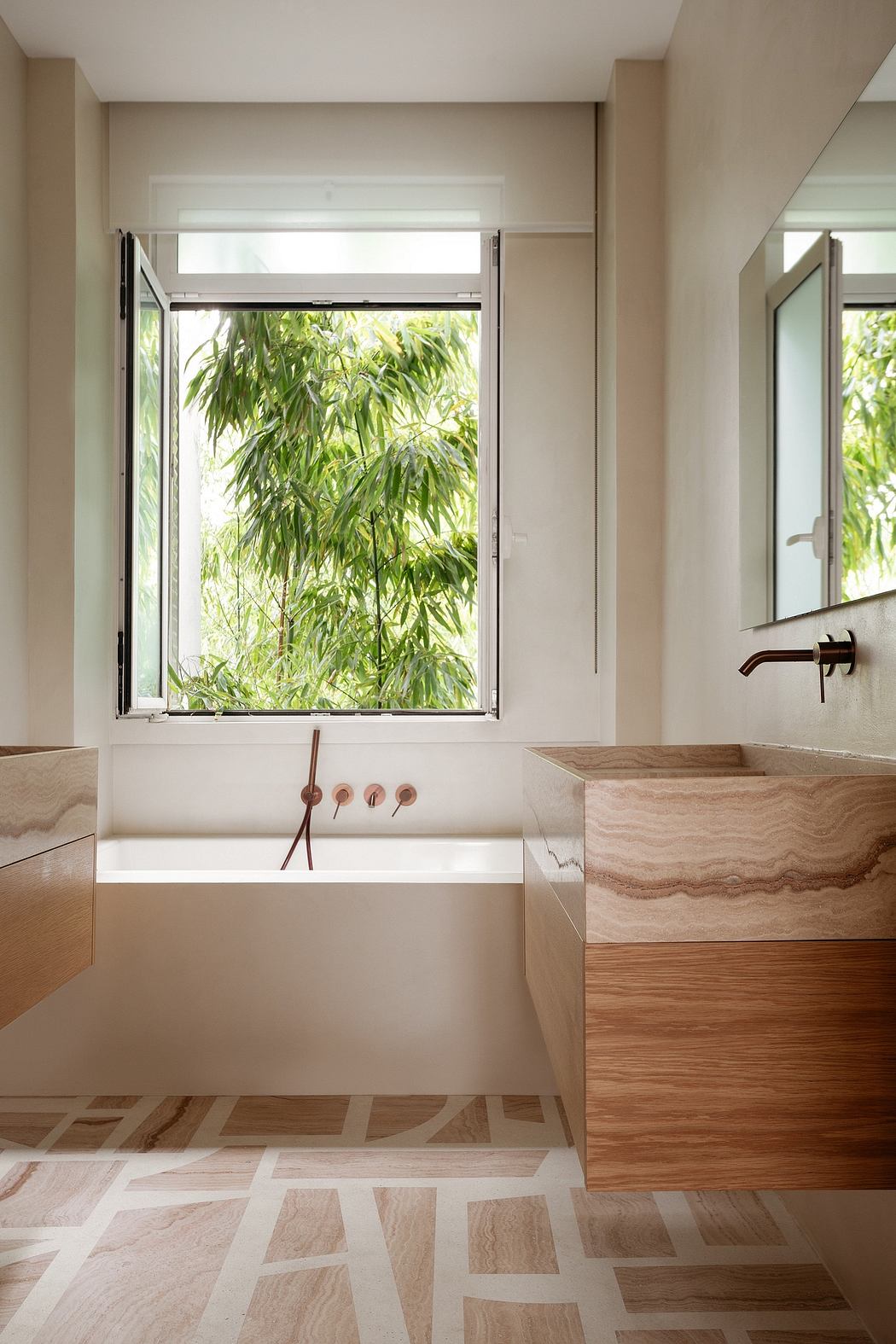 A modern, minimalist bathroom with a large window overlooking greenery, a wooden vanity, and a marble bathtub.
