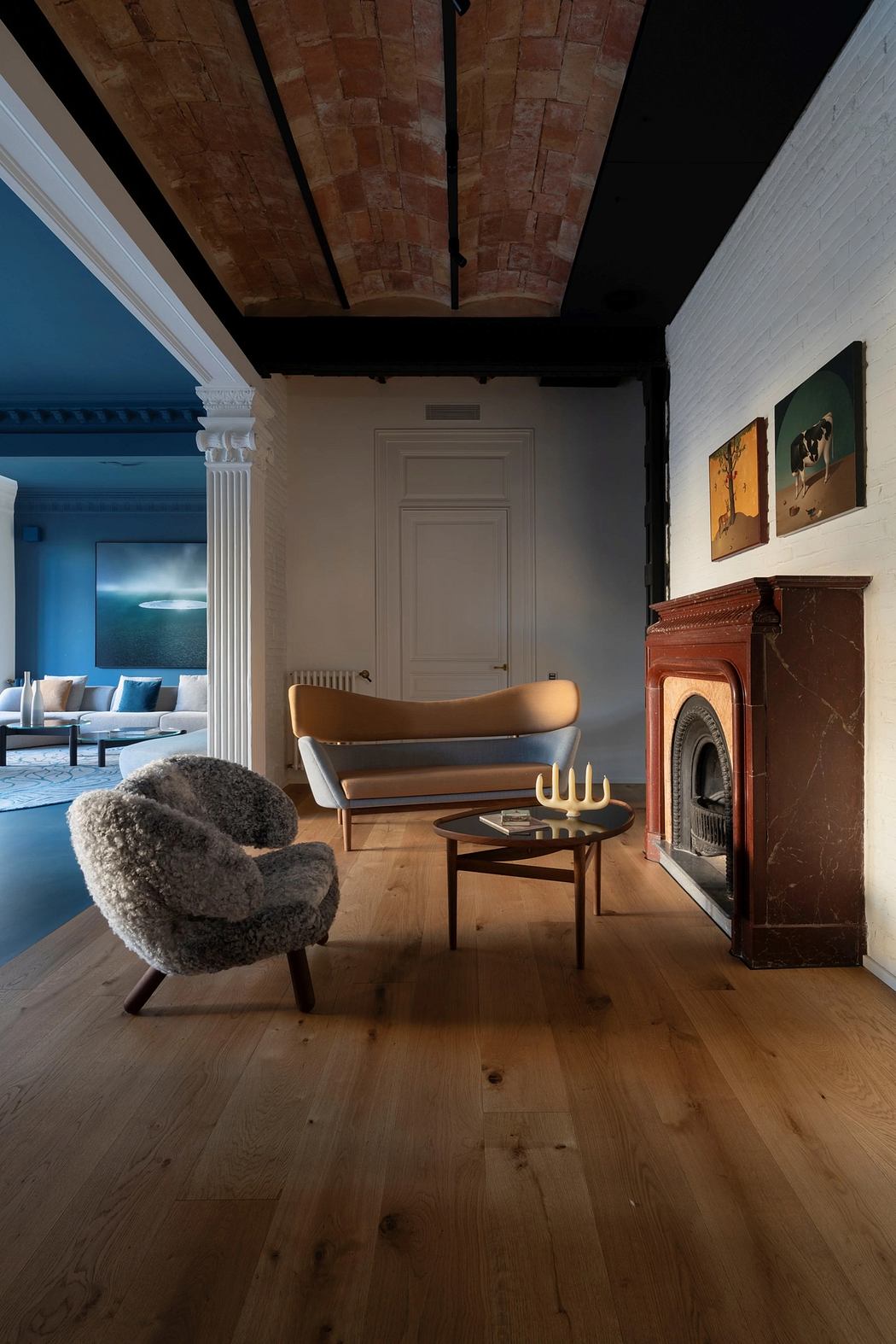 Charming room with exposed brick ceiling, wooden flooring, and a cozy armchair.