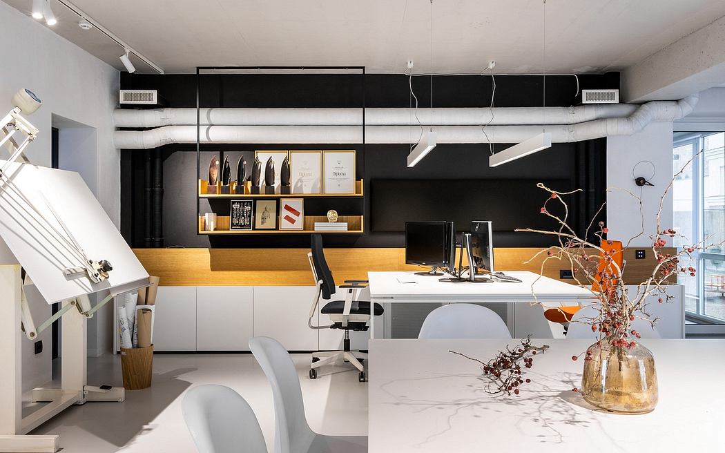 Sleek, modern office space with industrial-style shelving, hanging lights, and minimalist decor.