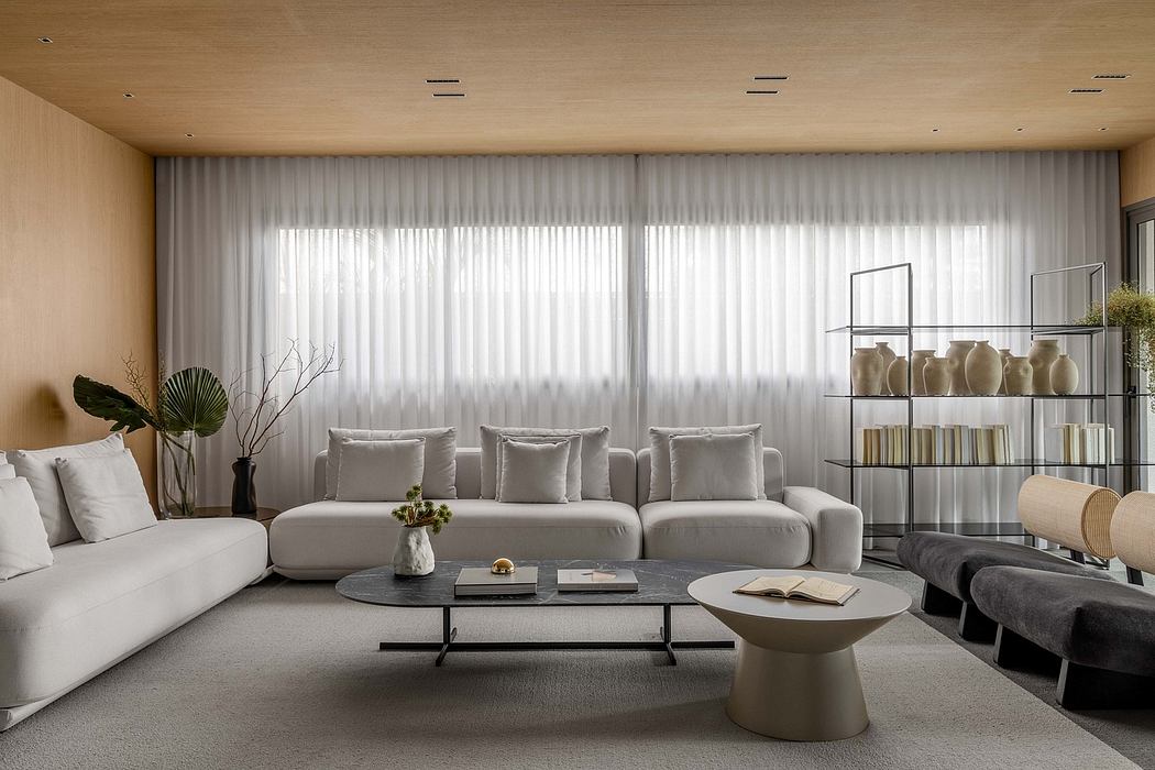 Sleek, modern living room with minimalist furnishings, large windows, and a stylish shelving unit.