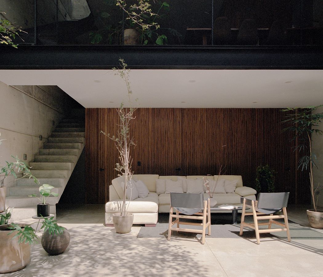 Warm, earthy interior design with wooden paneling, potted plants, and modern furniture.