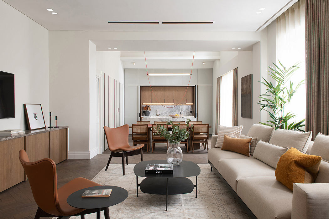 A modern, open-concept living space with warm tones, sleek furniture, and architectural details.