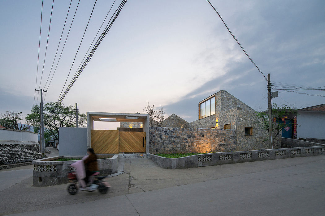 Striking stone and wood architectural design with ornate railings and outdoor lighting.
