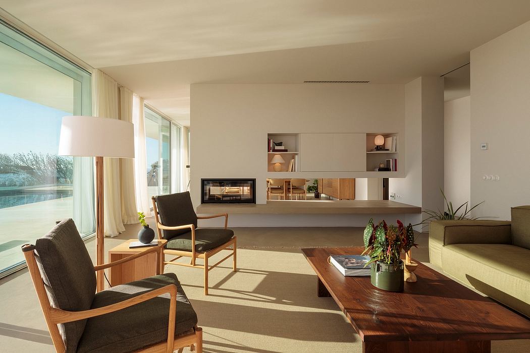 Spacious living room with modern furniture, fireplace, and extensive shelving.