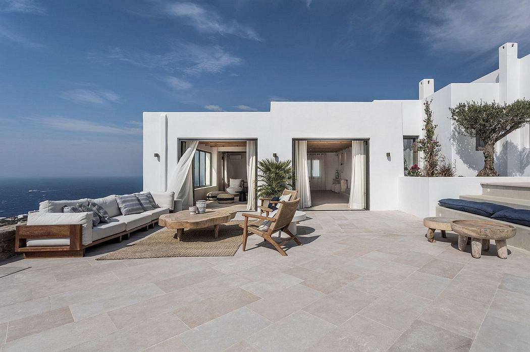 Stunning modern villa with minimalist white facade, expansive patio, and chic furnishings.