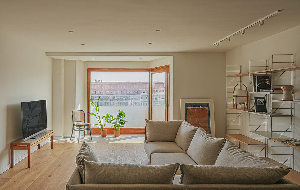 Minimalist living room featuring large windows, neutral color palette, and modernistic furnishings.