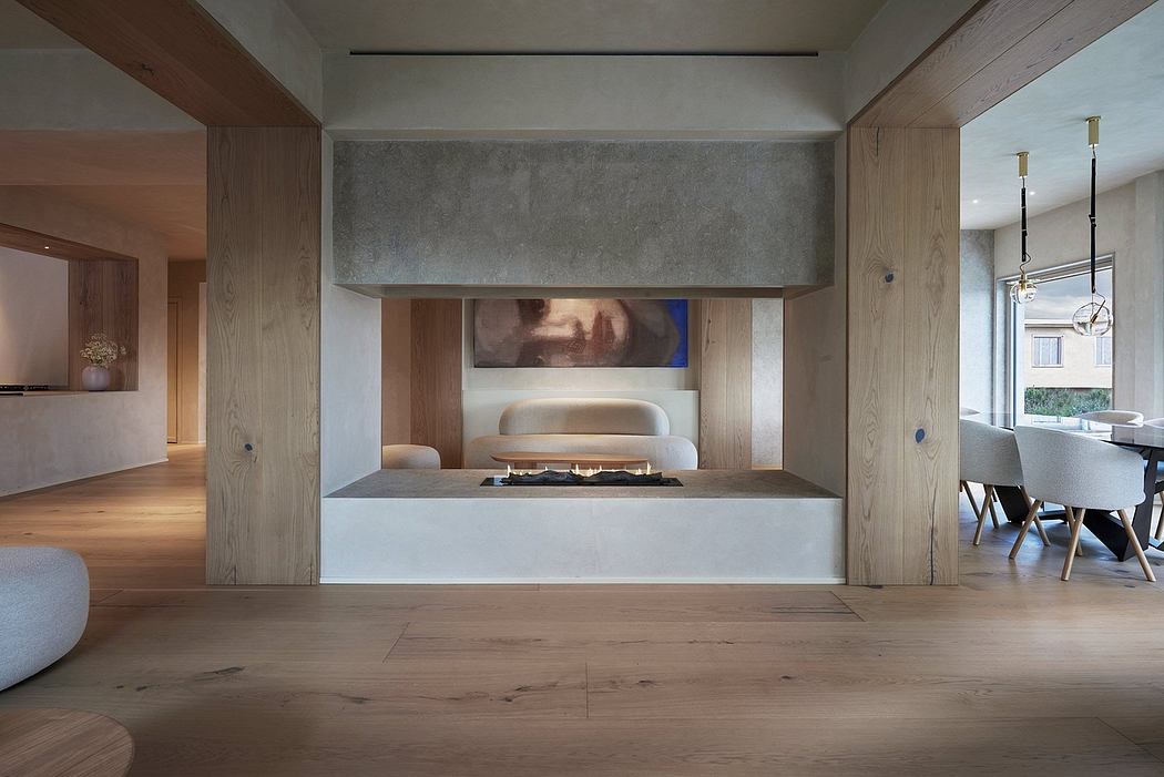 Spacious modern living room with wood paneling, concrete fireplace, and minimalist decor.