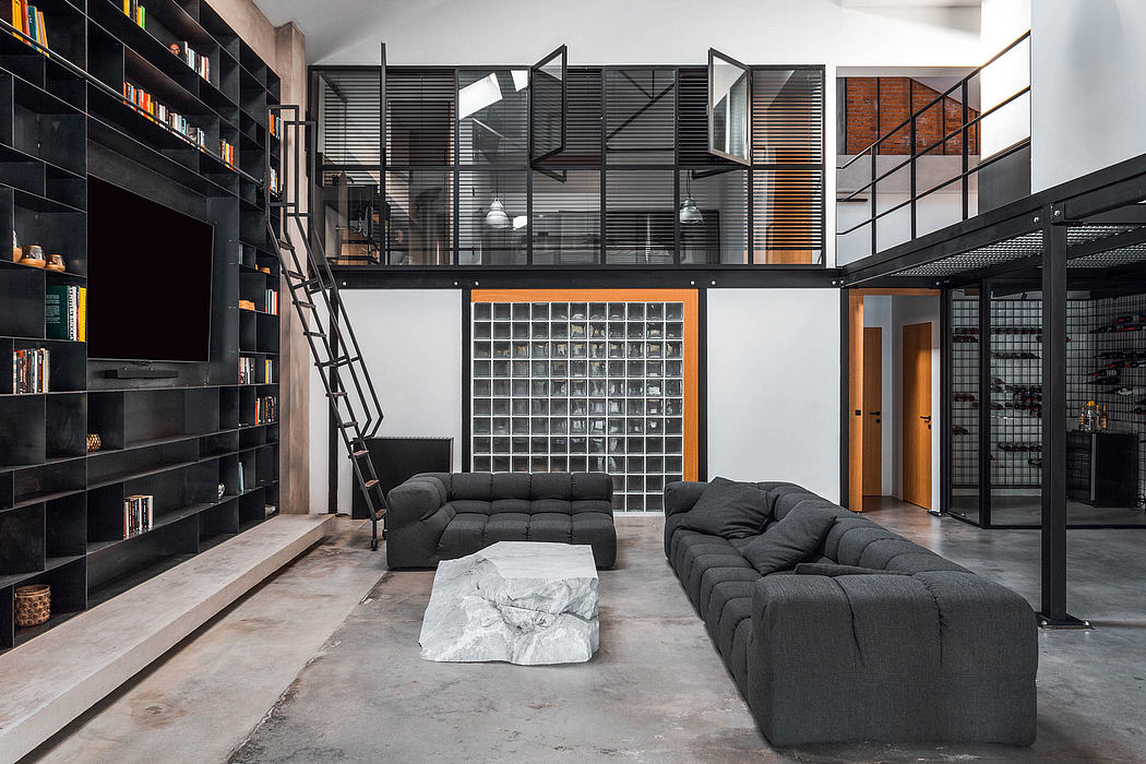 Striking industrial-style living space with black shelves, modular sofas, and glass block wall.