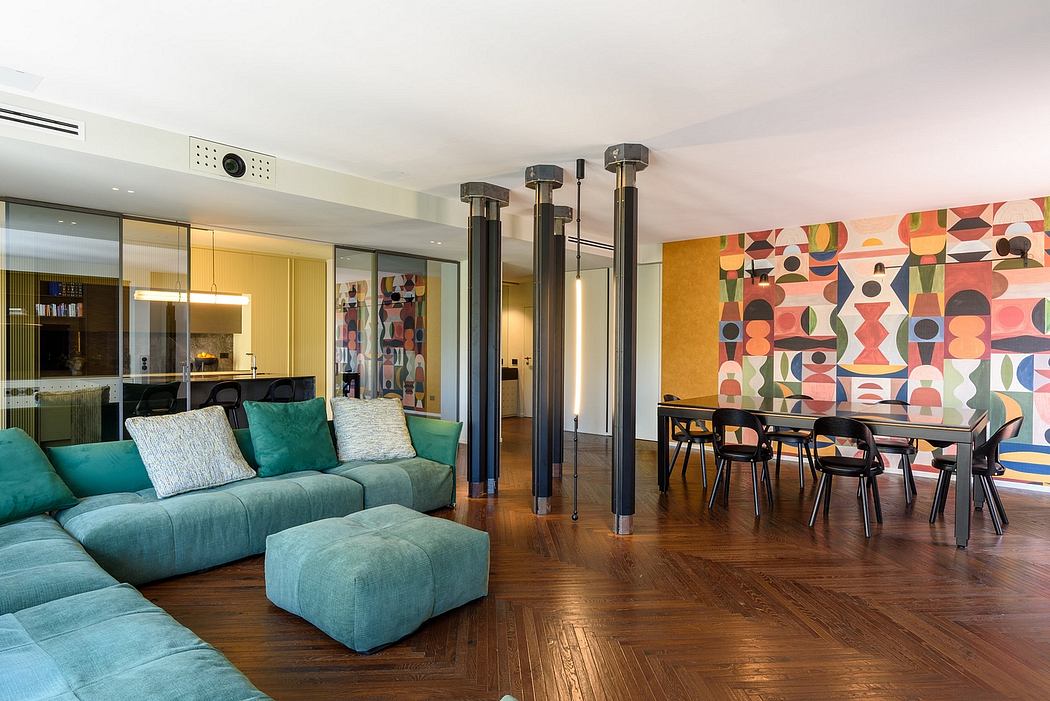 Modern open-plan living room with vibrant abstract wall art, plush green sofa, and sleek dining area.