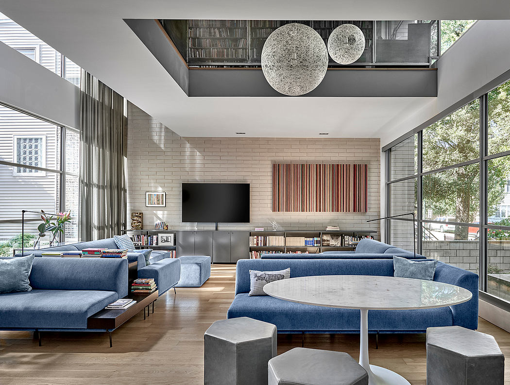 Contemporary open-concept living room with exposed brick walls, pendant lighting, and modular seating.