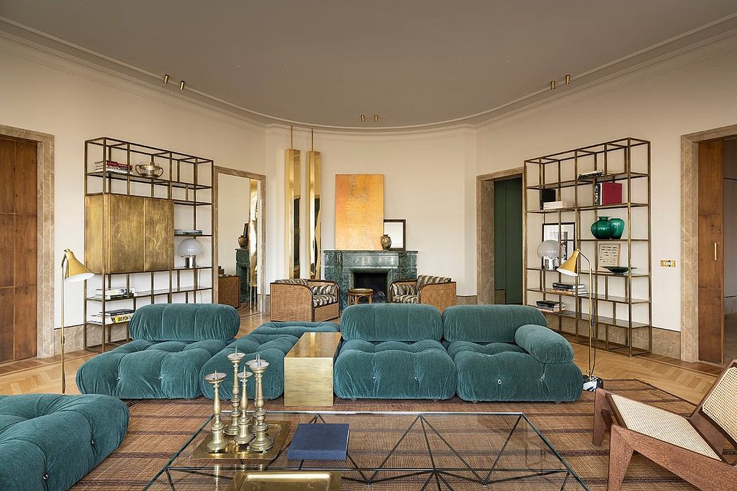 Spacious living room with plush teal sofas, metallic shelving units, and a fireplace.