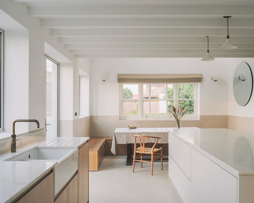 Minimalist kitchen-dining space with wooden beams, large windows, and a simple dining table.