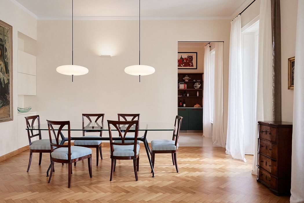 Elegant dining room with wood furniture, hardwood floors, and pendant lighting.