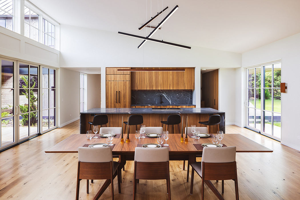 Spacious open-plan dining area with modern lighting, wood paneling, and stone fireplace.