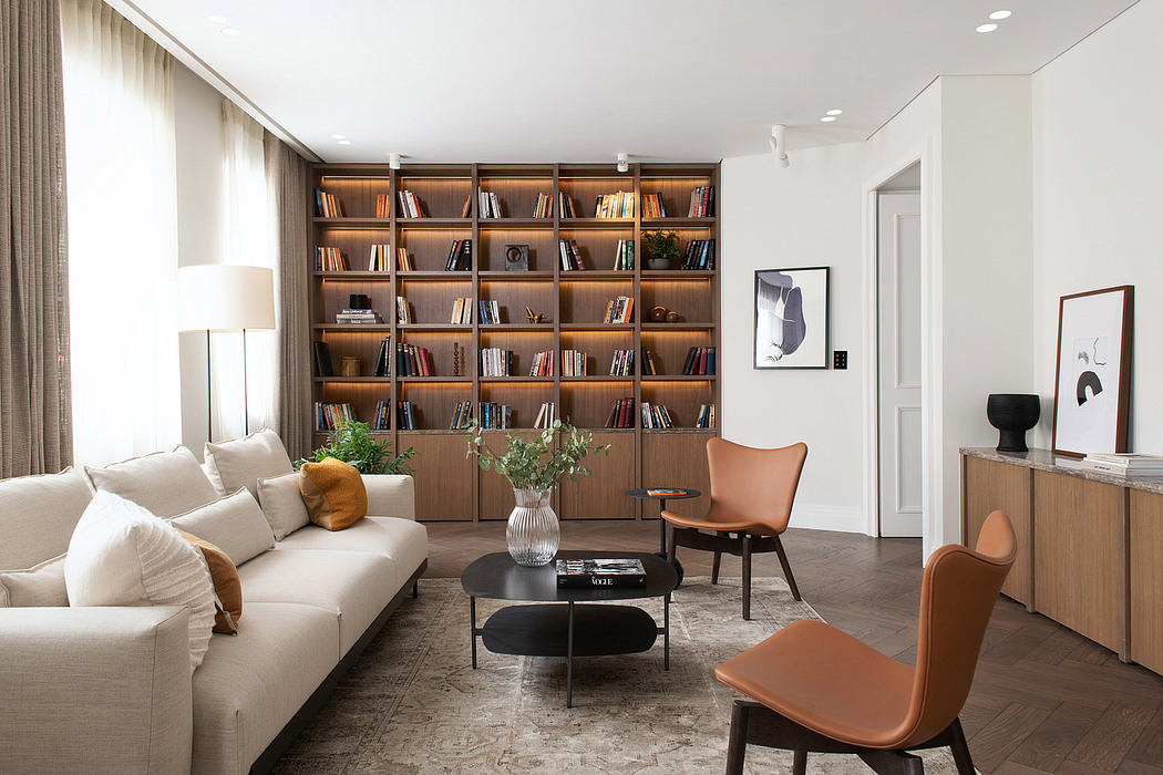 Cozy living room with modern furniture, built-in bookshelf, and artwork accents.